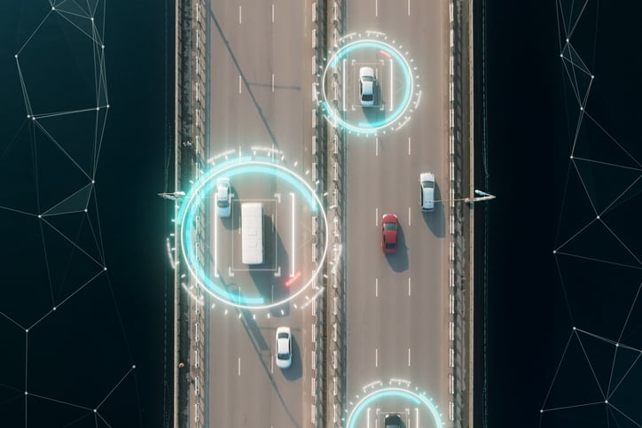 4k aerial view of self driving autopilot cars driving on a highway with technology tracking them, showing speed and who is controlling the car. Visual effects clip shot.