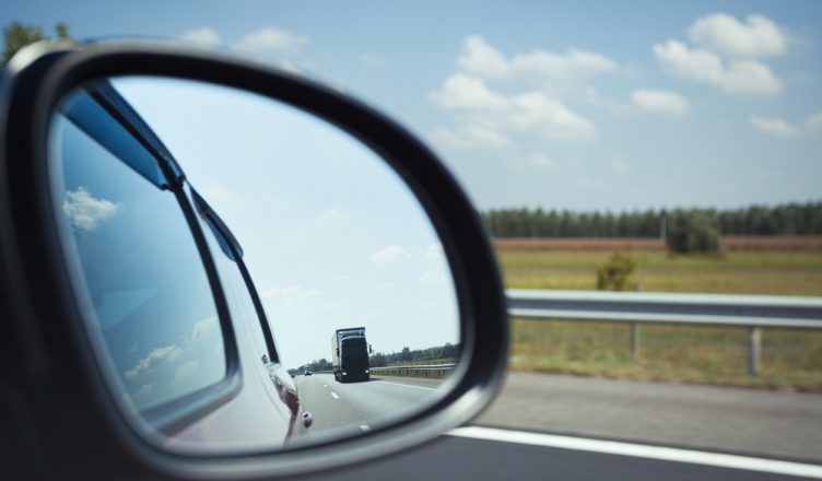 Safe driving tip showing you should always look in the mirror before taking a turn or changing lane.