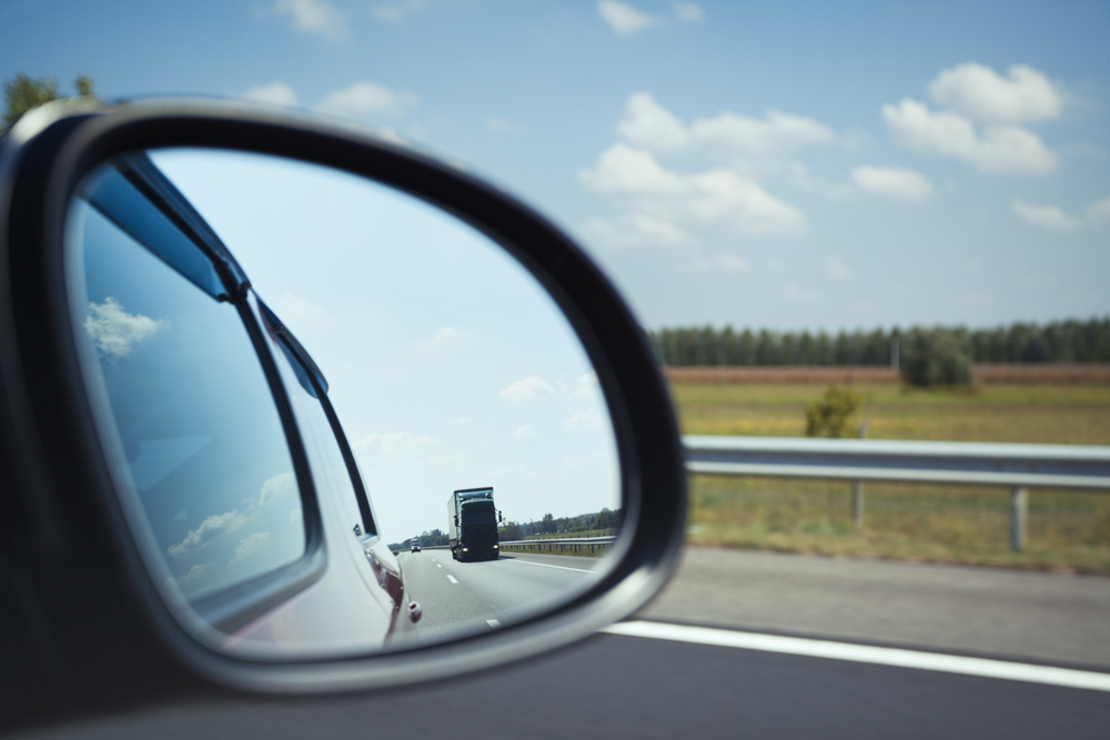 Safe driving tip showing you should always look in the mirror before taking a turn or changing lane.