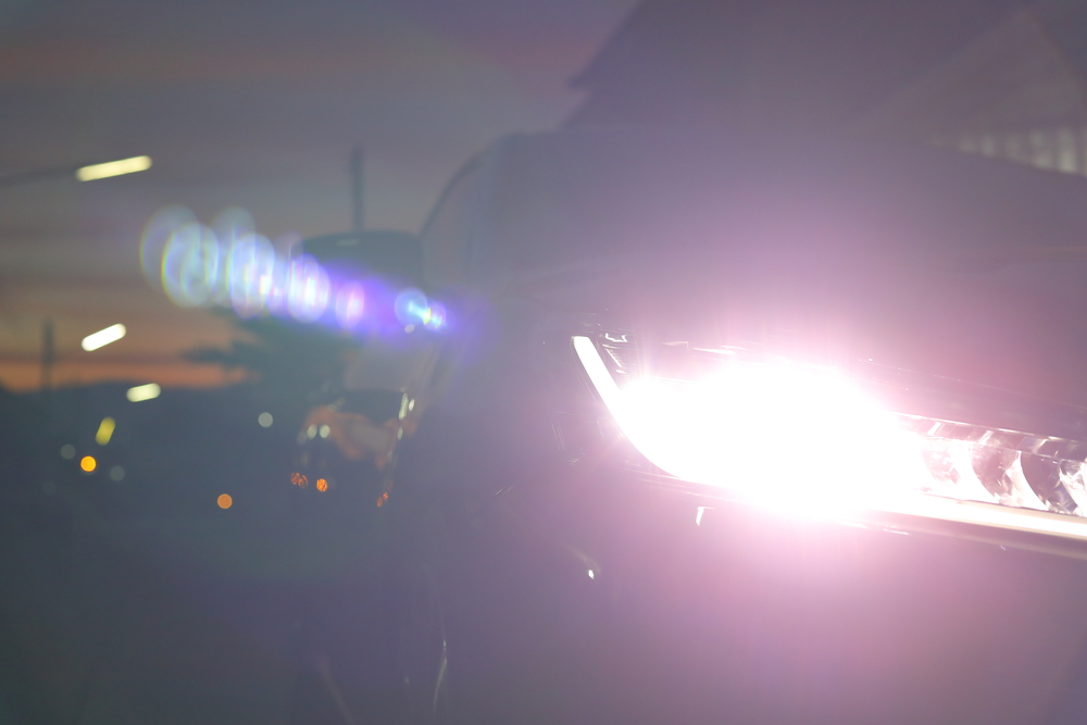 Car headlights with a high beam could cause trouble to opposing traffic.