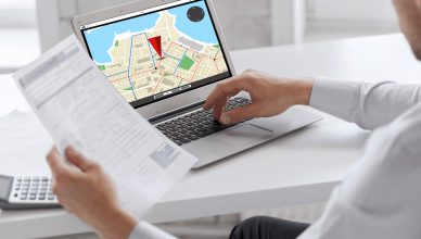 Businessman tracking vehicles on a laptop