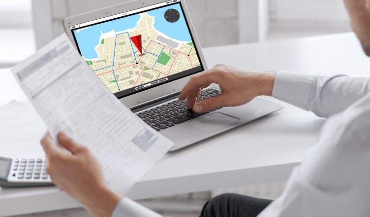 Businessman tracking vehicles on a laptop