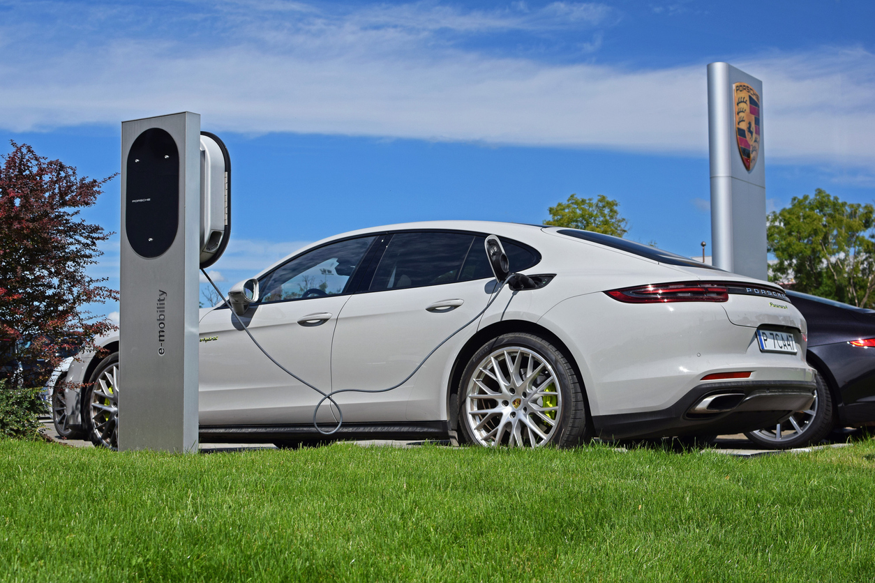 White Porsche Panamera E Hybrid an electric vehicle at charging station
