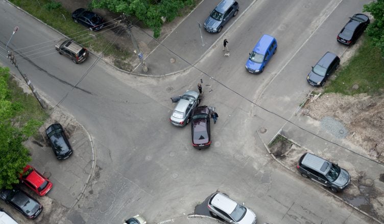 Two cars collided at an intersection due to aggressive driving