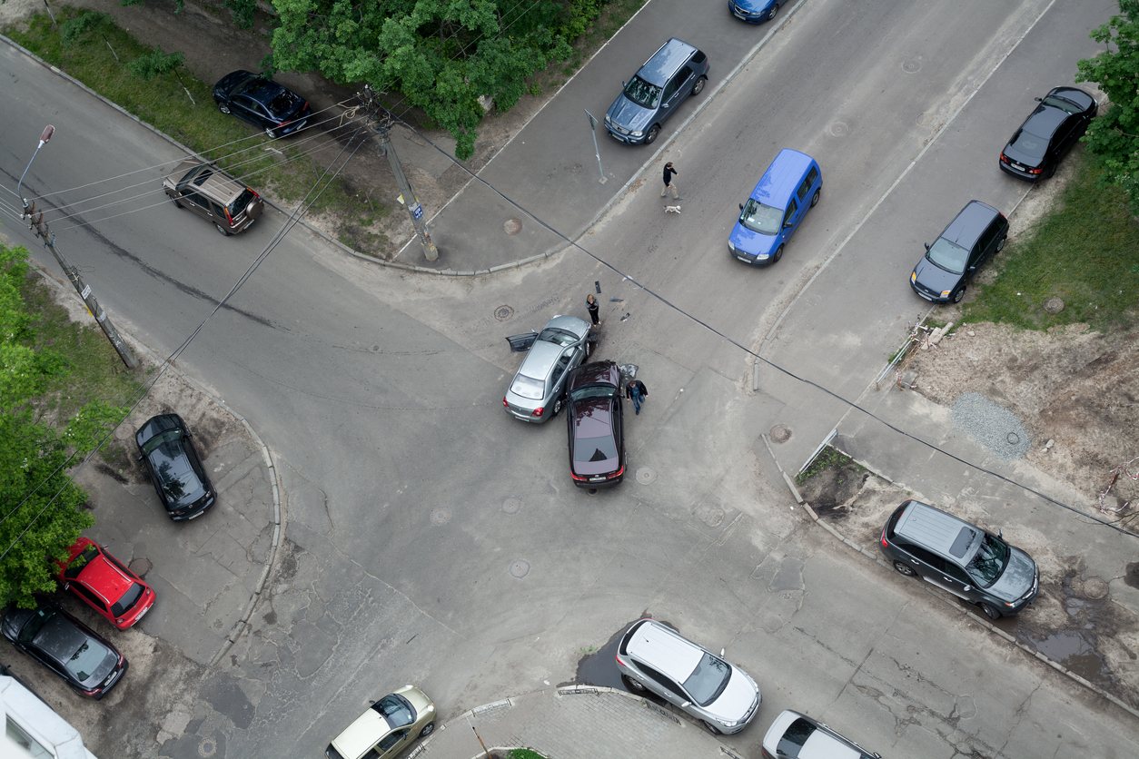 Two cars collided at an intersection due to aggressive driving