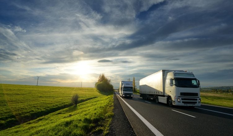 Commercial trucks on highway adhering to defensive driving