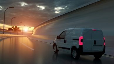 running white delivery van on empty highway