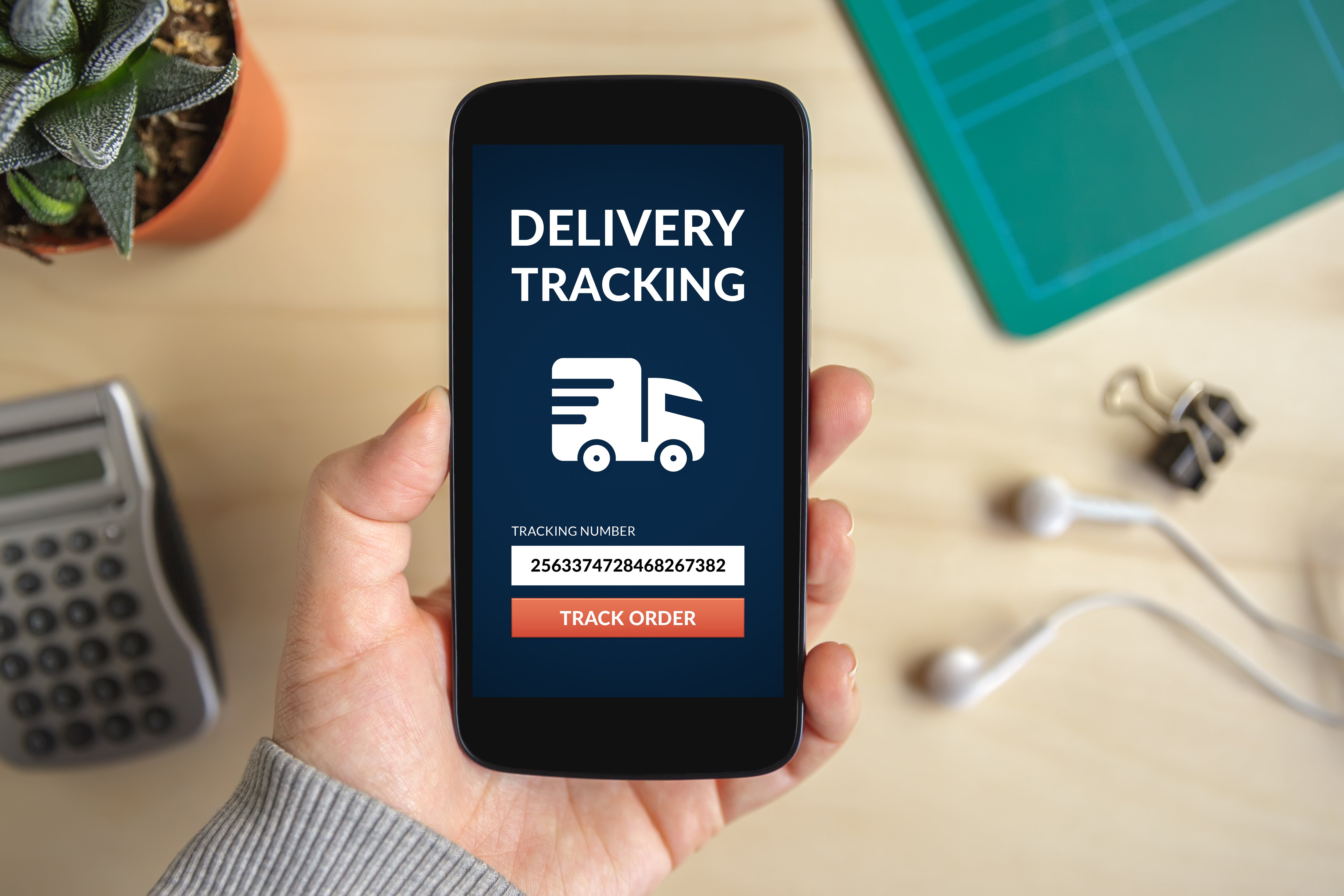 customer using delivery tracking mobile app to monitor package delivery status