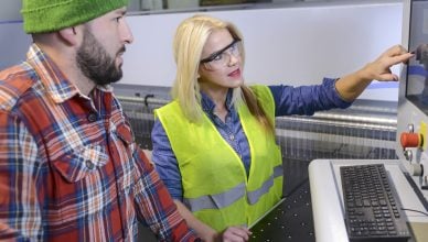 Lady industry worker imparting training to fellow worker