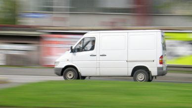 White delivery van driving fast for middle mile delivery