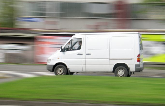 White delivery van driving fast for middle mile delivery