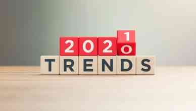 "2020" and "2021" Last-Mile delivery trendsTrends written red wood blocks sitting on a wood surface in front of a defocused background. Horizontal composition with copy space.