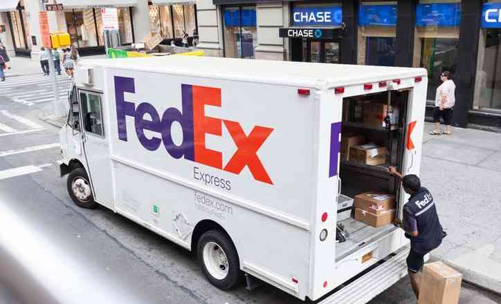 Example of buying FedEx Routes: FedEx Express truck in midtown Manhattan. FedEx is one of the leading package delivery services offering many different delivery options.