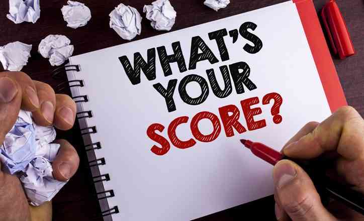 Conceptual hand writing showing What Is Your On-time in Full Score Question. Business photo text Tell Personal Individual Rating Average Results written by Man Notepad wooden background Marker Paper Balls