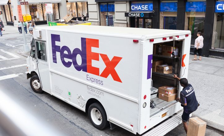 New York City, NY, USA - July 7, 2015: FedEx Express truck in midtown Manhattan. FedEx is one of the leading package delivery services offering many different delivery options.