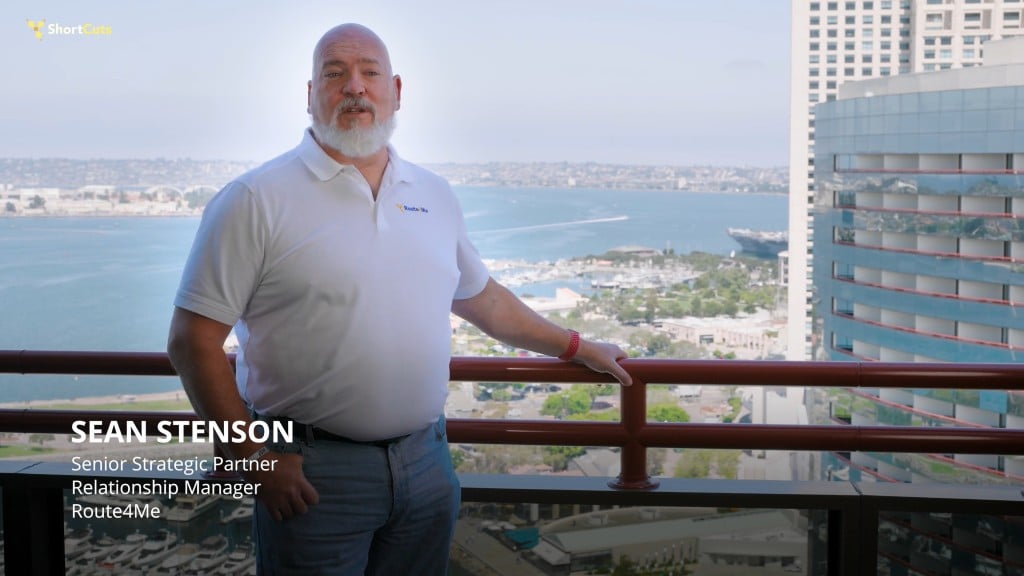Sean Stenson, Senior Strategic Partner Relationship Manager at Route4Me, speaks during a ShortCuts interview with a city skyline and waterfront in the background, discussing last mile efficiency and customer experience.
