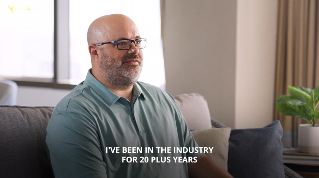 Jim Farkas in teal polo shirt speaking during an interview with text overlay: "I've been in the industry 20+ years."